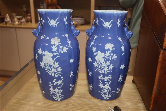 A pair of 19th century Chinese blue ground vases, with white floral decoration